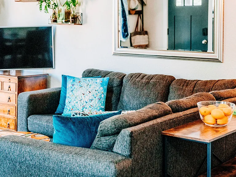 Living room with smart TV, space to relax, and bright French doors leading outdoors to the backyard.