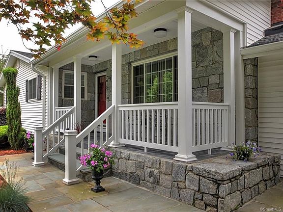 Pretty blue stone walk way lead you to stone covered front porch!