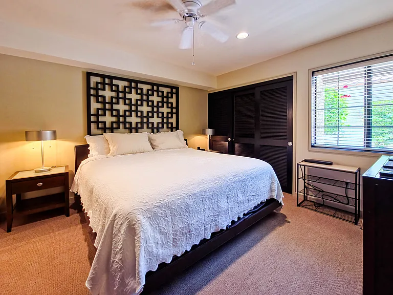 Secondary bedroom with king sized bed. Includes bedside tables, large closet, TV and dresser.