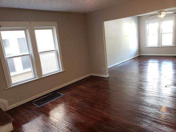 Dining and living room with hardwood floors & large windows