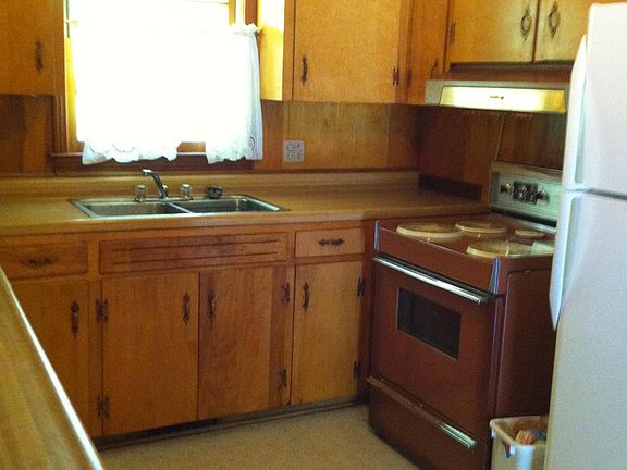 Kitchen with a bar that opens to the den