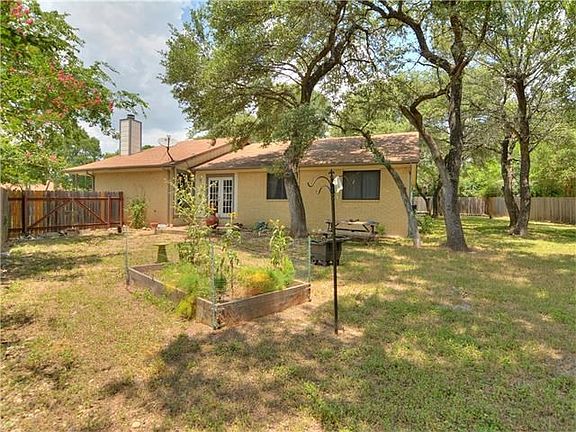 Tons of beautiful tress and a veggie garden in this huge back yard