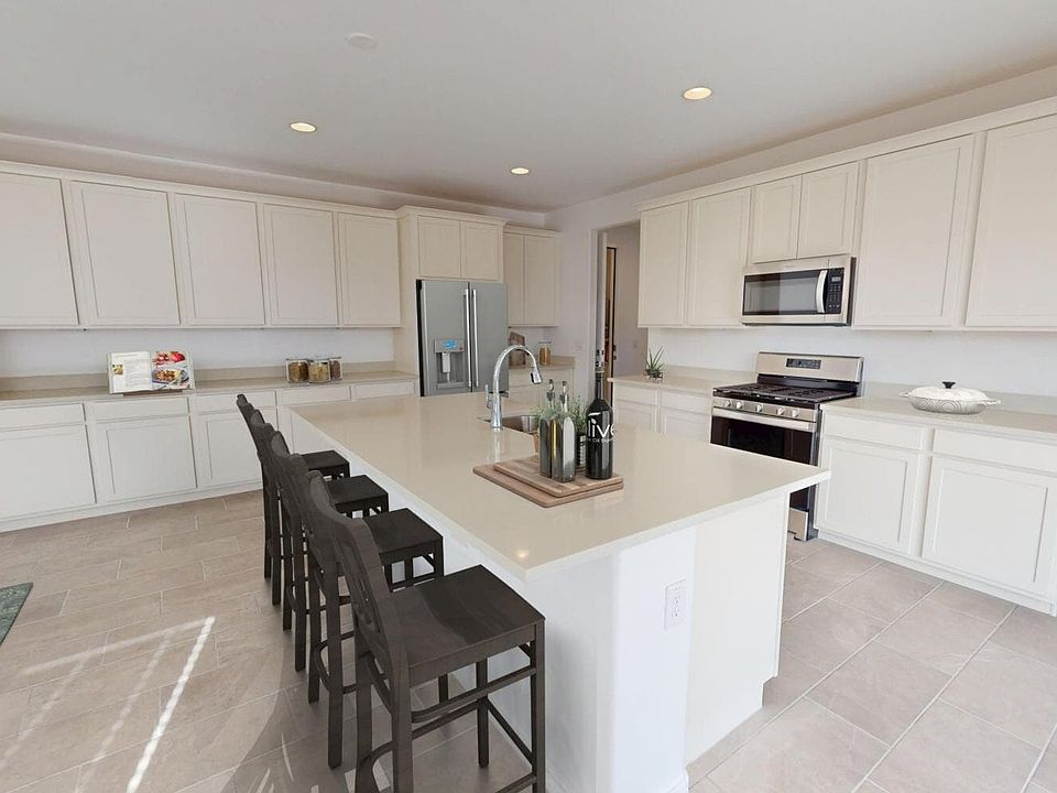 An image of the Kitchen with virtually rendered furnishings in a Skylar plan home at Mariposa in Blo