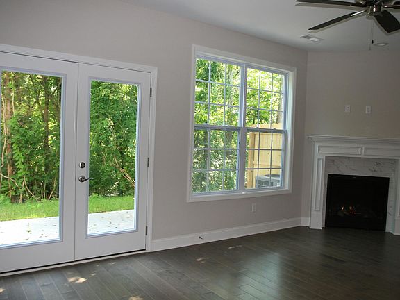 Dining/ Living area with Chimney and view of patio yard and towards the greenway