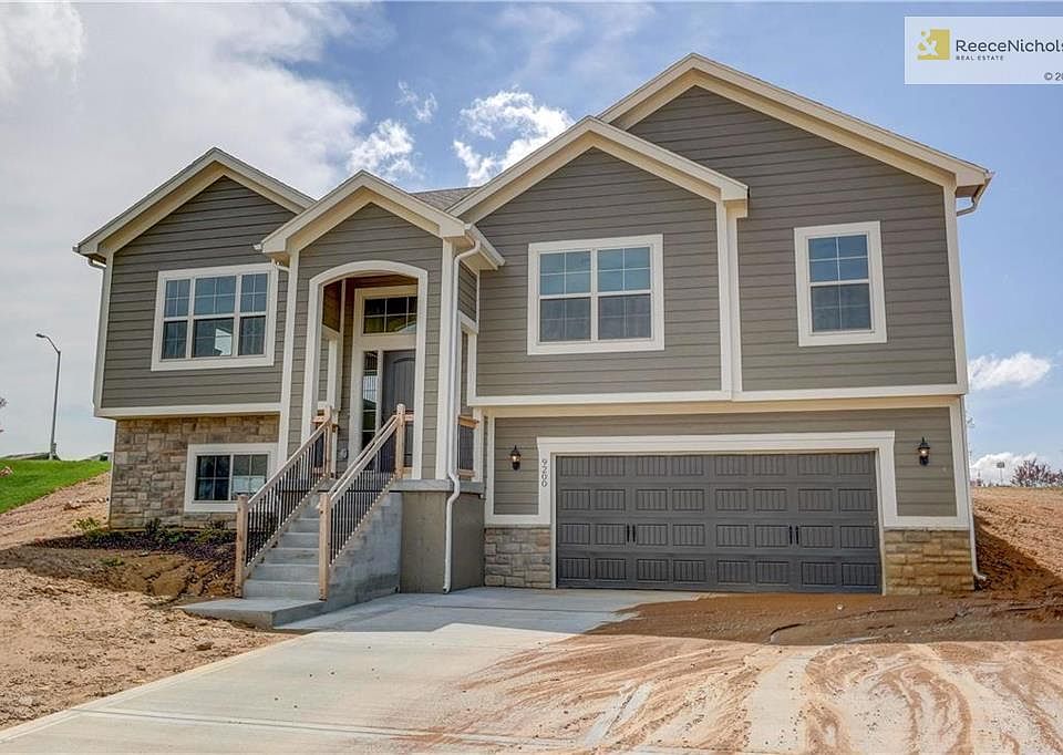Carriage style steel doors with decorative hardware, pre-wired for door openers. Insulated fiberglass front door with sidelights and grills. Front landscape package per communityrequirements. Traditional front lap and stone veneer exterior.