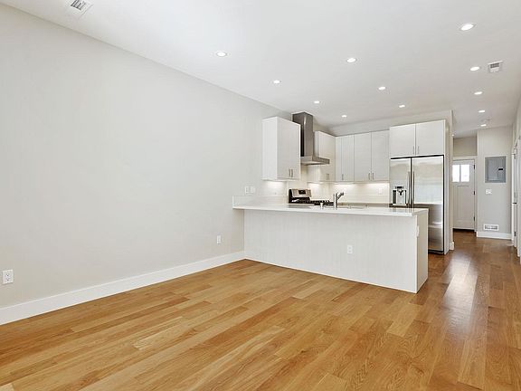 Bright kitchen with skylight. Kitchen island next to dining