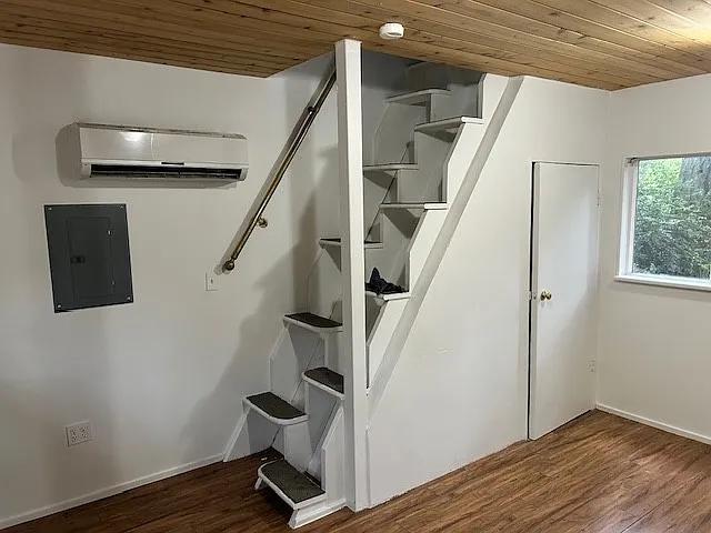 Storage closet under the stairs in the living room. Stairs go to the bedroom, bath, and loft.