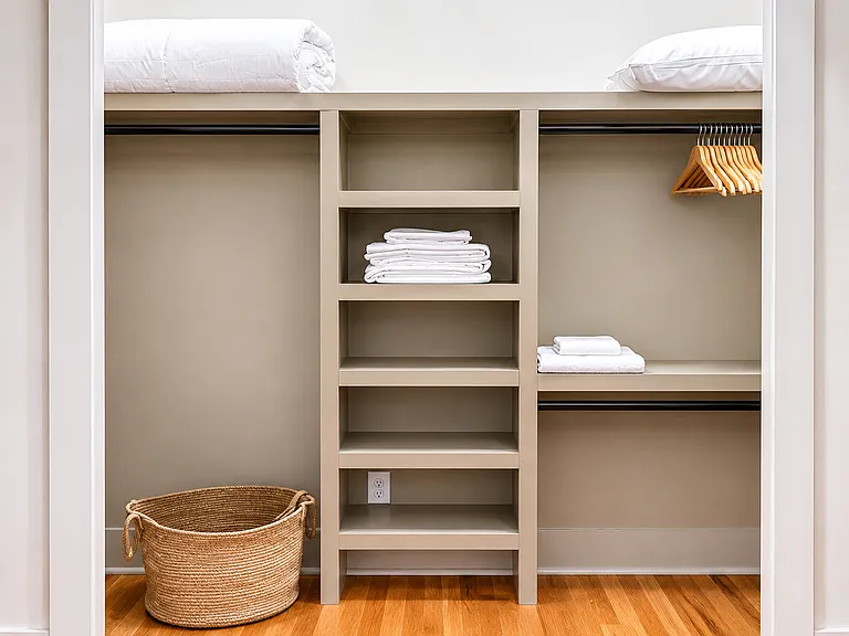 One of two large closets in the Edgewood Suite, stocked with everything you need for your stay including hangers, laundry baskets, extra bedding, pillows and towels.