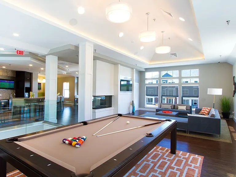 Game room with pool table, fireplace and flatscreen TVs