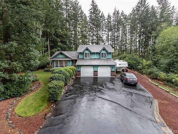 Dozens of rhododendrons thrive on over half an acre of woodlands and well kept lawn. Don't worry though, the automatic sprinkler system takes care of the watering. Imagine the colorful blooms in spring time! 