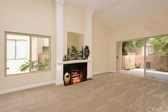 UPGRADED new carpet, hearth, new windows in LR, soaring ceiling about 18' living room with private patio and water feature view!