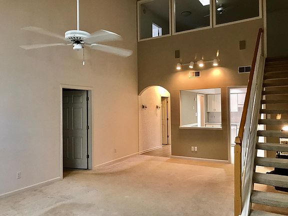 Kitchen features passthrough to living room and easy access to master bedroom. Stairs lead to second living room area and third bedroom.