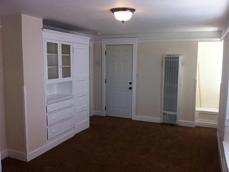 Built ins and front door. bedroom door to left