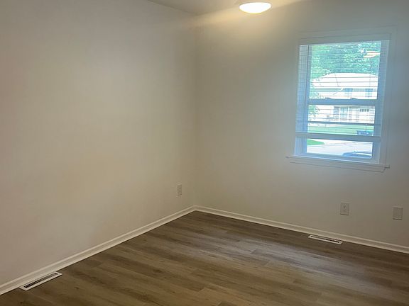Master bedroom with all new flooring and ceiling fan.