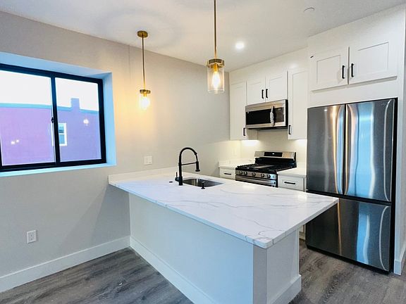 New floors and gleaming countertops 
10ft high ceilings