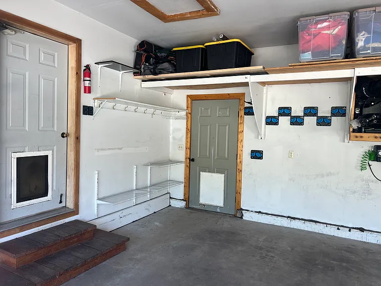 2 car garage with ski storage, plenty of shelving, hooks, etc.