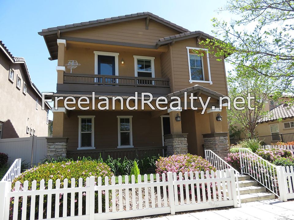 Front of house with front porch overlooking park. Front yard gardener included with rent.