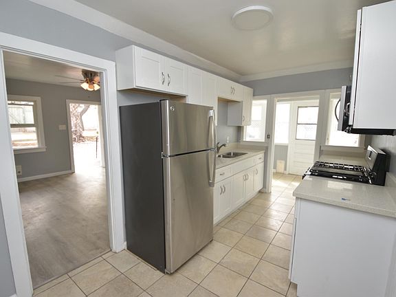 REMODELED KITCHEN WITH QUARTZ COUNTERS AND STAINLESS STEEL APPLIANCES