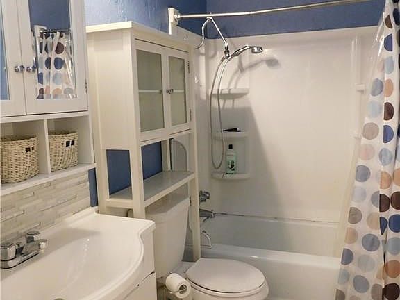 Bathroom  next to kitchen and laundry room. It was an add on. Cast iron tub.