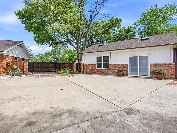 Separate guest house with kitchen, bed, full bath, and living area.