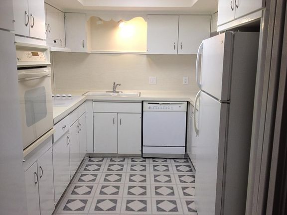 Kitchen with flat top stove, stain less steel refrigerator