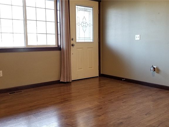 Step into your large Entry or cozy Living Room. Notice the beautiful decorative glass on front door.