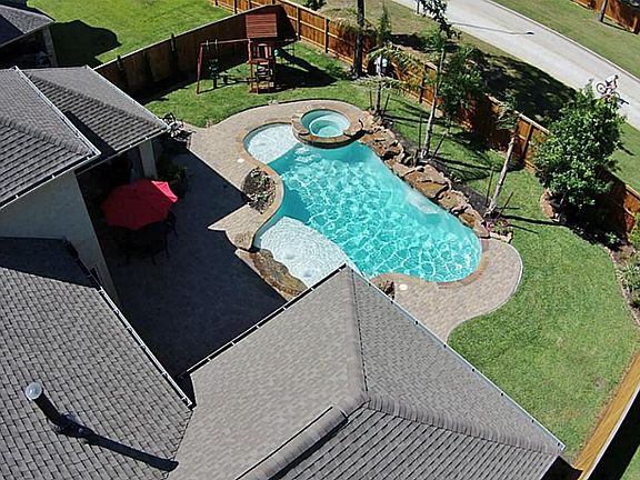 You'll never want to leave this backyard! Pool with ozone system, spa, tanning ledge and splash pad. Play set can stay! Huge covered patio with outdoor kitchen, speakers and cobblestone flooring!
