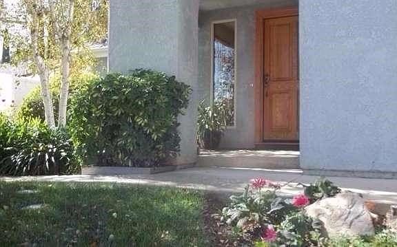 Such a warm and welcoming entry up to a handsome wooden door access! Behind pillar is a lovely small