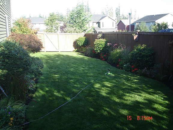 Large side yard lawn and garden area all maintained by sprinkler system