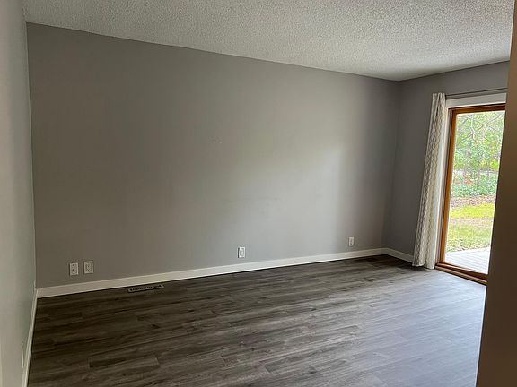 Living room area with large sliding glass door that leads to the front patio