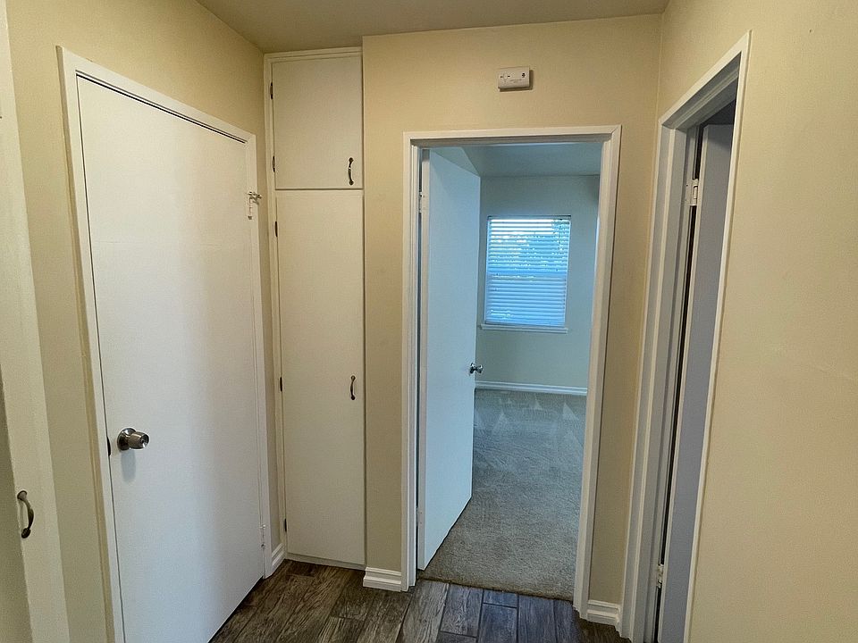 Primary on left, guest door straight ahead and bathroom door on the right. Two hall storage sections- one in view and one on the far left.