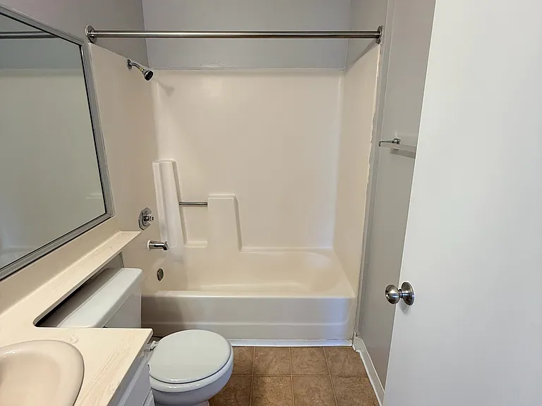Full bathroom with shower over bathtub