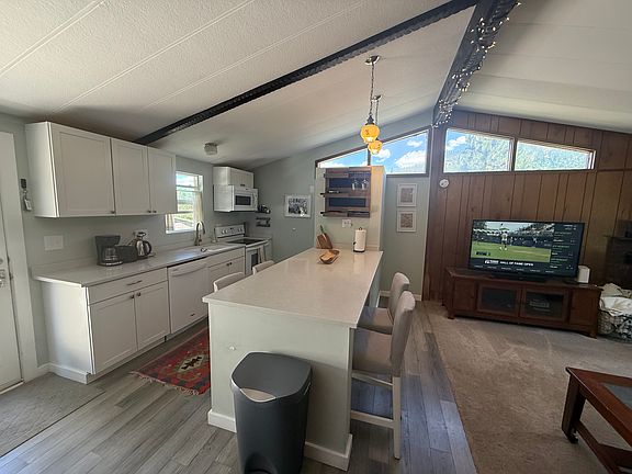 Kitchen with large island and four chairs