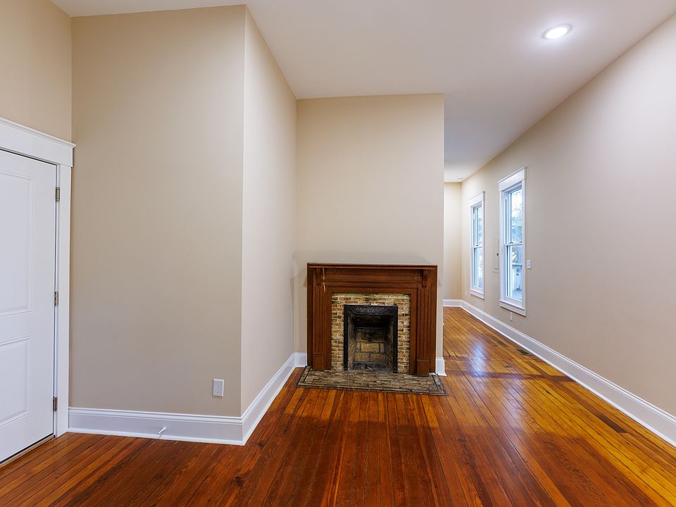 Original decorative fireplaces have been restored to maintain the historic character of the unit.