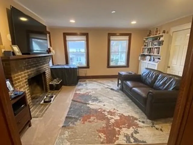 Living room with fireplace and front door