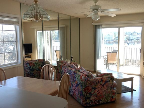Main living area - fully furnished with laminate flooring.