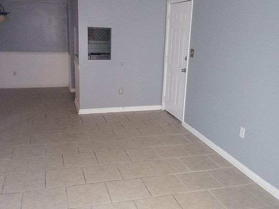 front door entrance, living room, dining room in the back and peek-a-boo window for kitchen