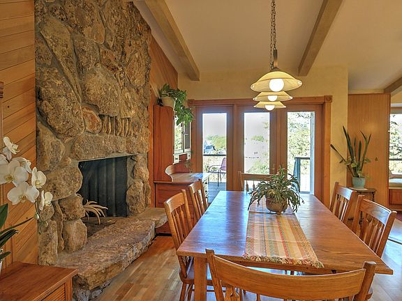Dining area with door to deck and kitchen to the right.