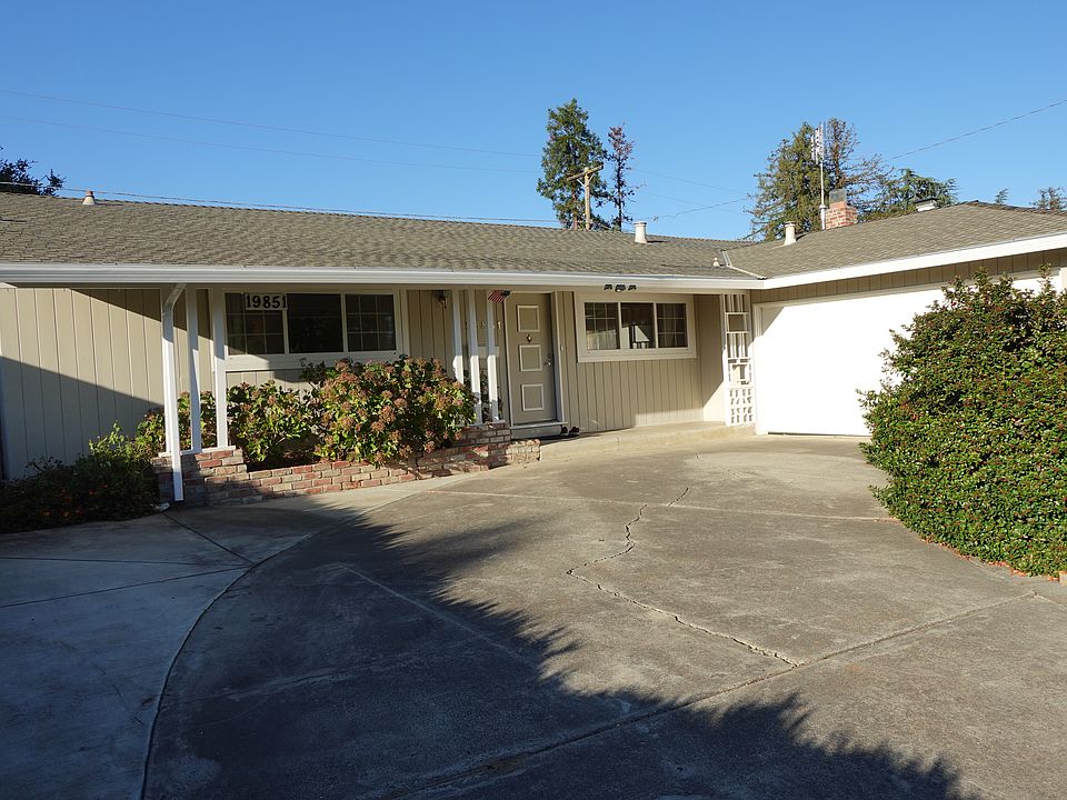Large driveway, 2-car attached garage providing ample parking and storage.