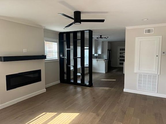 View of living room, dining room and kitchen while standing at front door