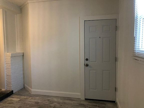 Spare room, with door that leads to back alley.