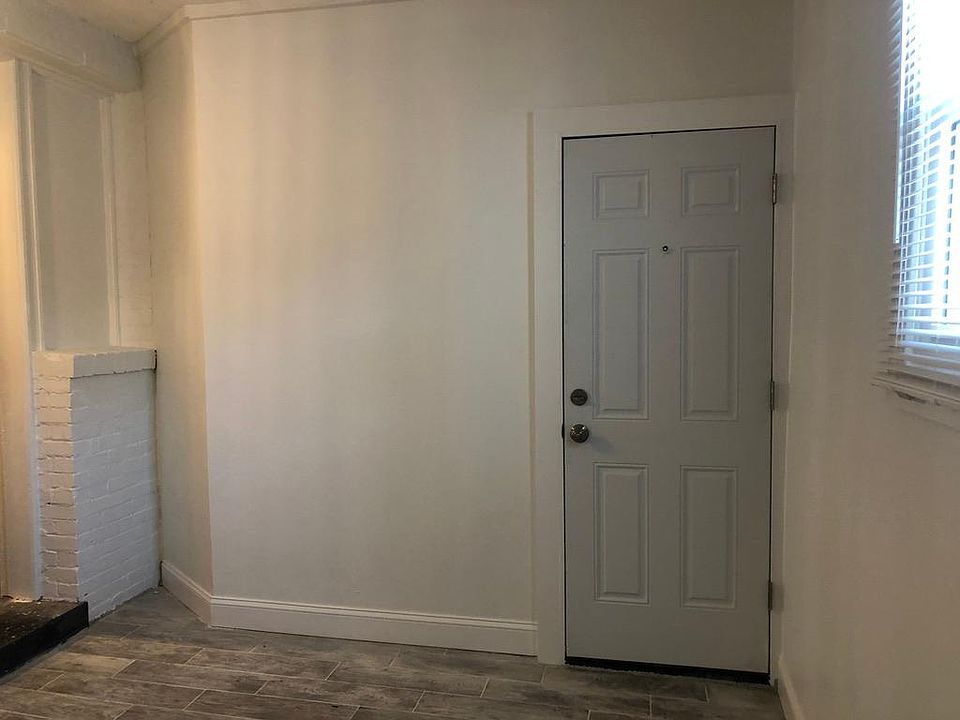 Spare room, with door that leads to back alley.