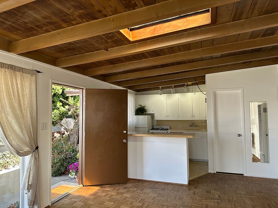 front door, skylight in living room and kitchen beyond