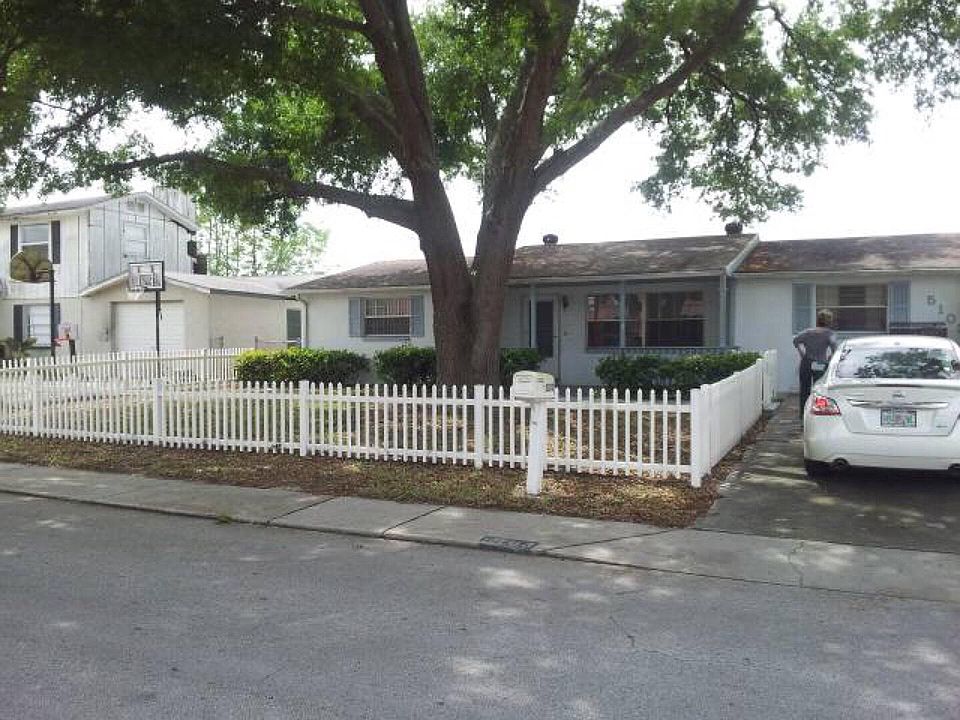 Beautiful oak tree and white picket fence