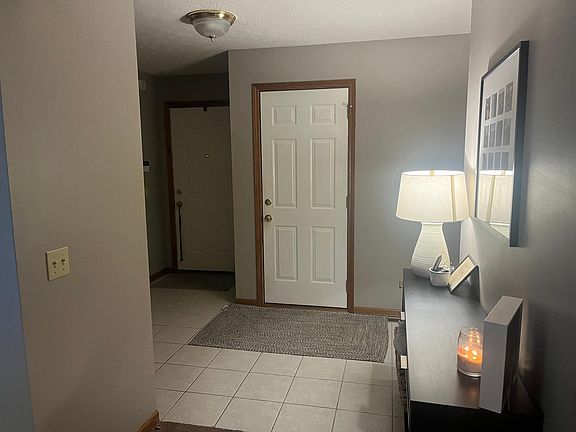 Foyer with furniture looking at entry door and garage door