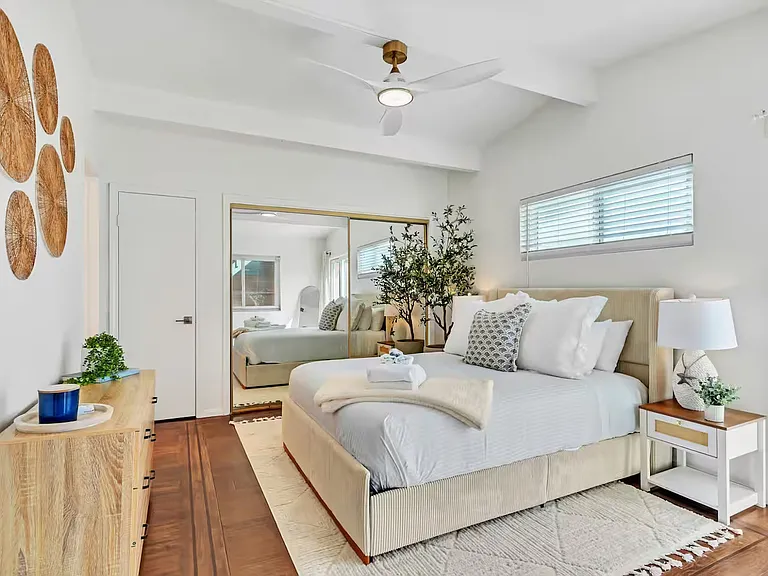 The bedroom 2 features a queen bed and direct access to the balcony