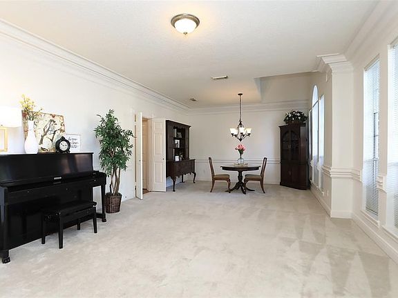 Formal living and ding room off the entry with wall of windows.