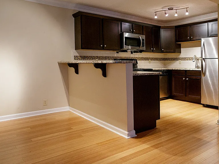 Experience the harmony of modern design in this open kitchen and living area, perfect for culinary creativity and cozy gatherings.