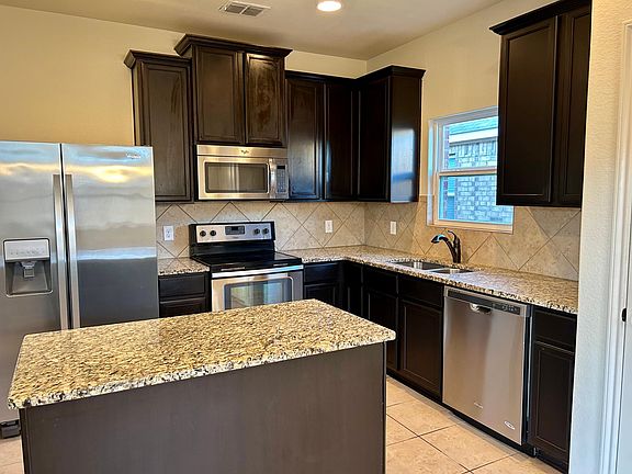Kitchen with granite counters, appliances will stay