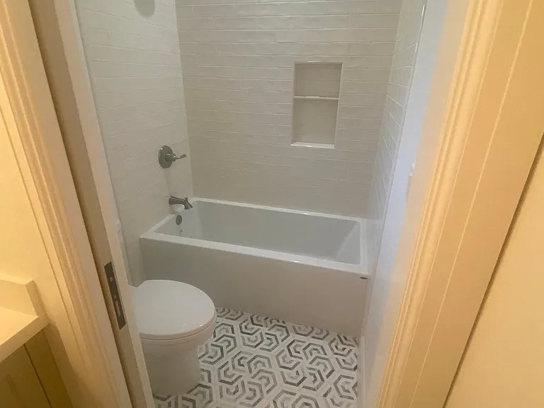 Tub and toilet with locking pocket door